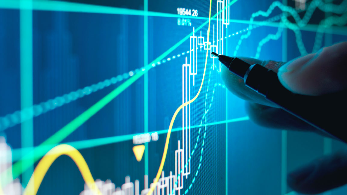 Someone pointing a pent to a spot on a graph